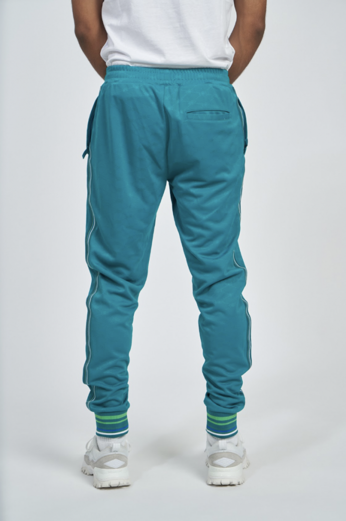 Pantalón Umbro Monogram Track Quetzal...